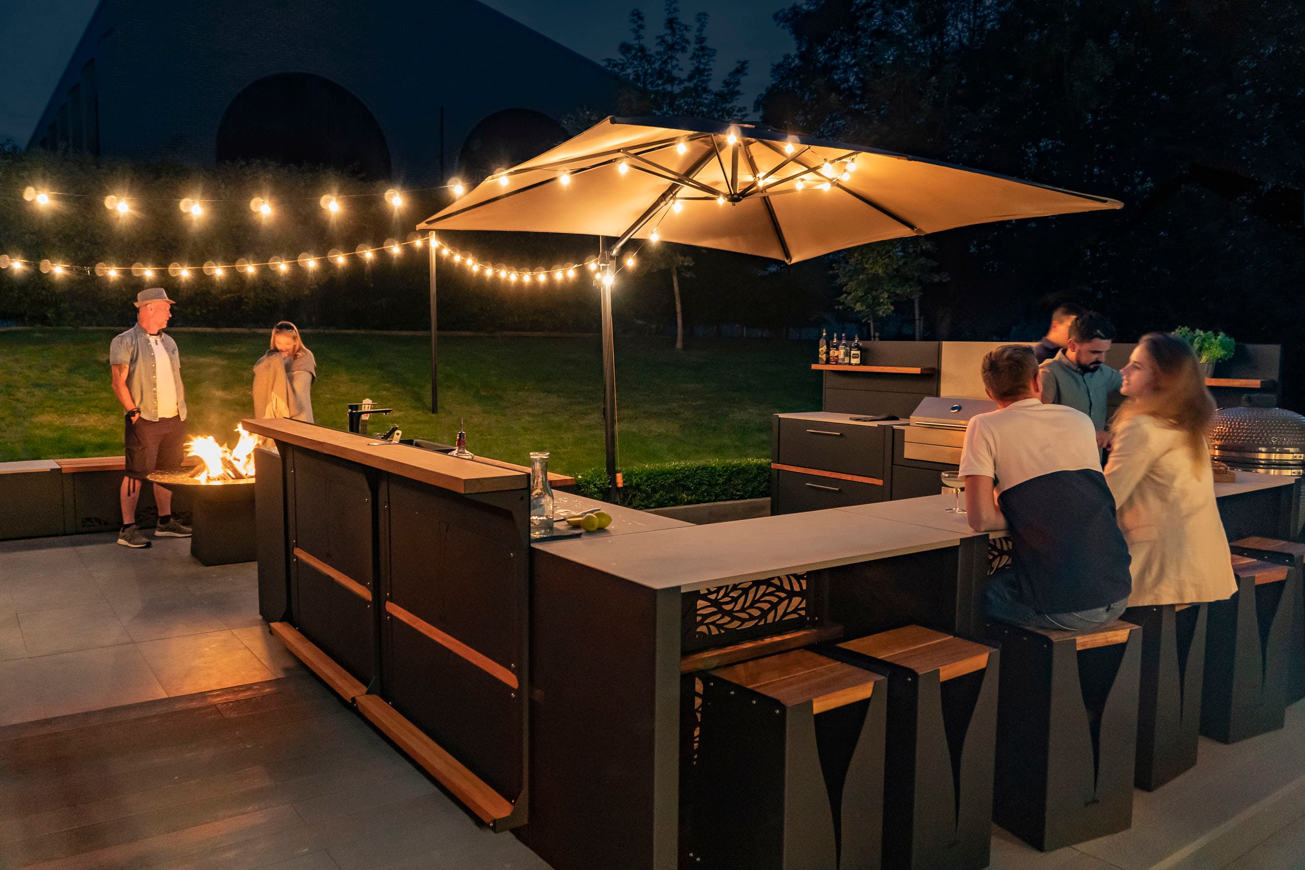 Grillo outdoor kitchen at dusk with ambient lighting and seating